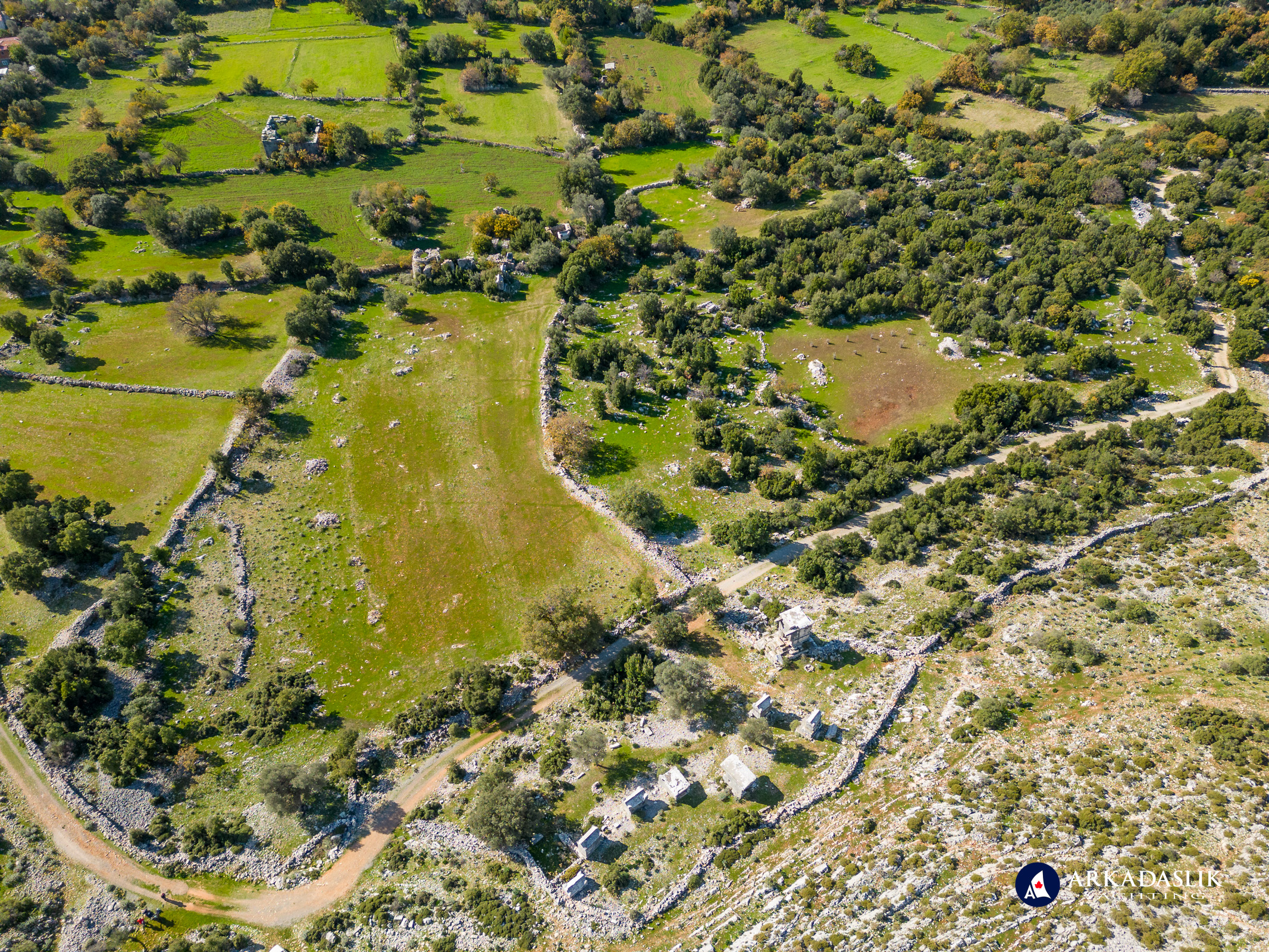 Wide aerial view showing Sidyma’s terraces and rural setting