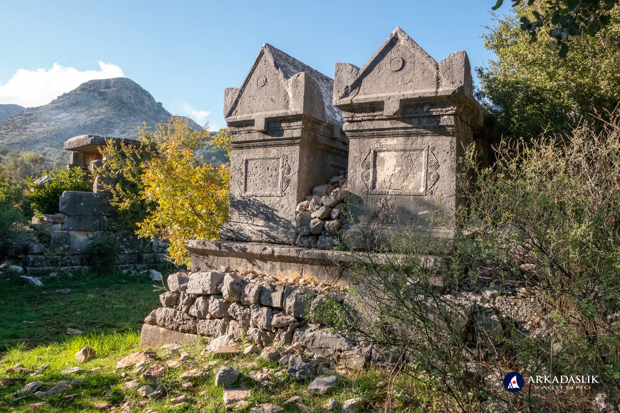 Two elevated monumental tombs on a stone platform at Sidyma
