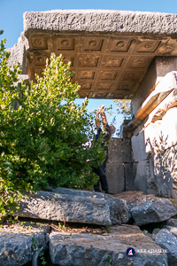 Visitor photographing the coffered ceiling of the Sidyma tomb