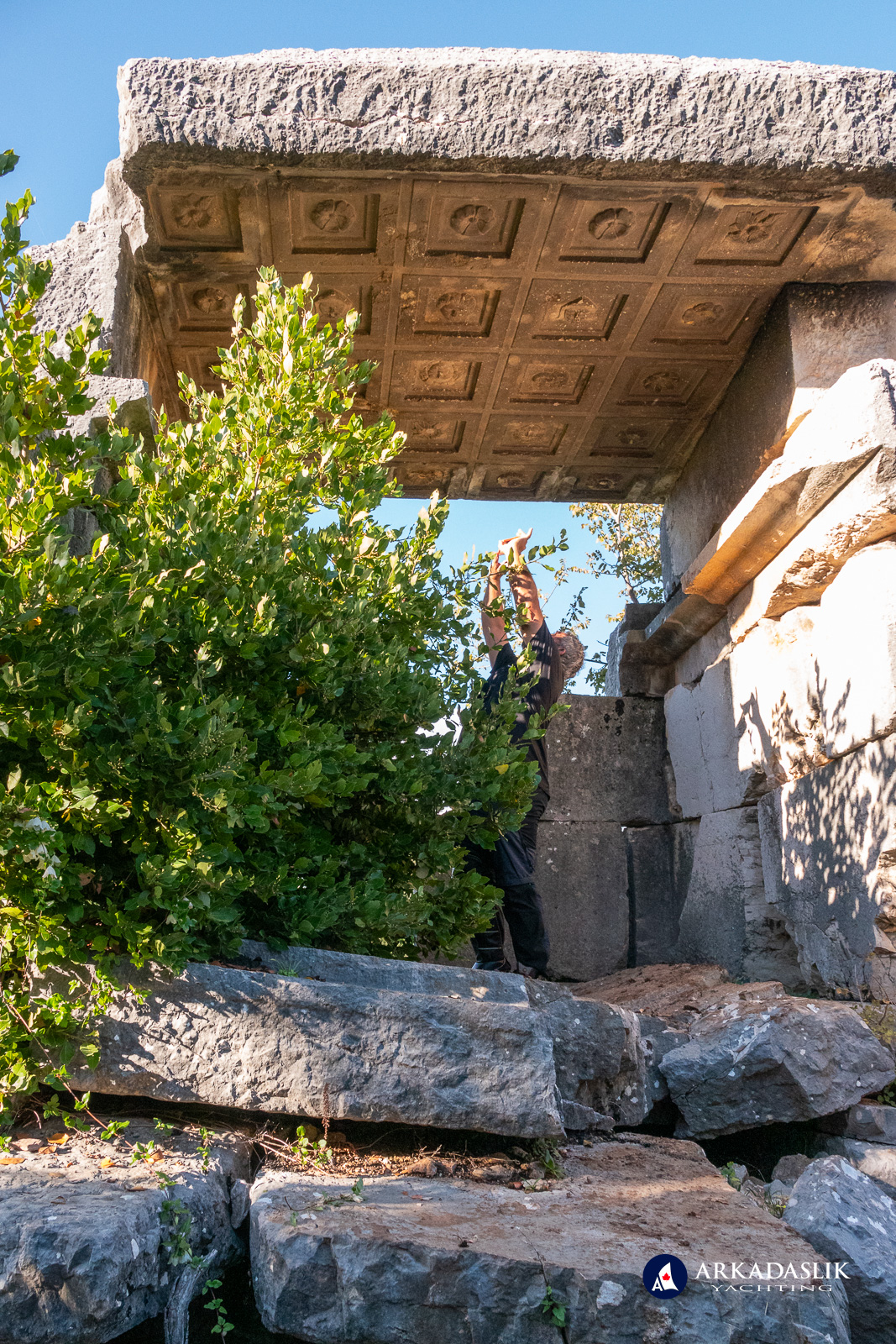 Visitor photographing the coffered ceiling of the Sidyma tomb
