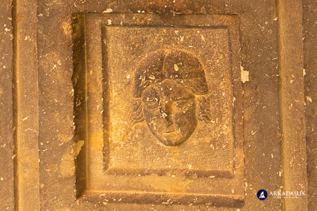Carved face on the cassette-ceiling of a Sidyma tomb
