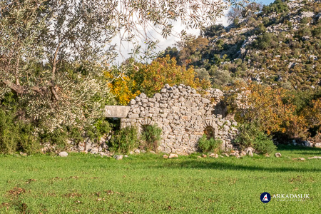 Ruins of a stone church with arched doorways at Sidyma