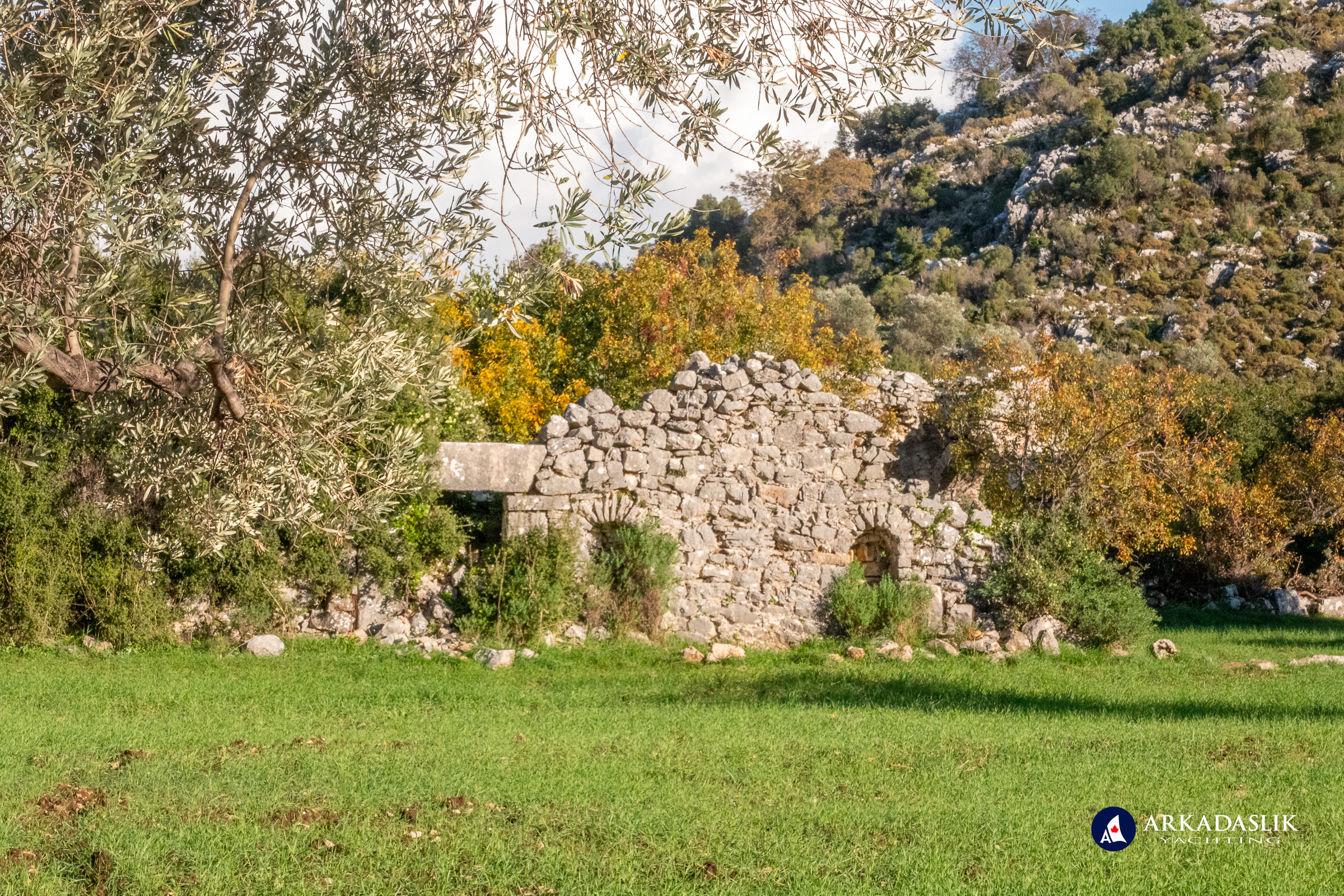 Ruins of a stone church with arched doorways at Sidyma