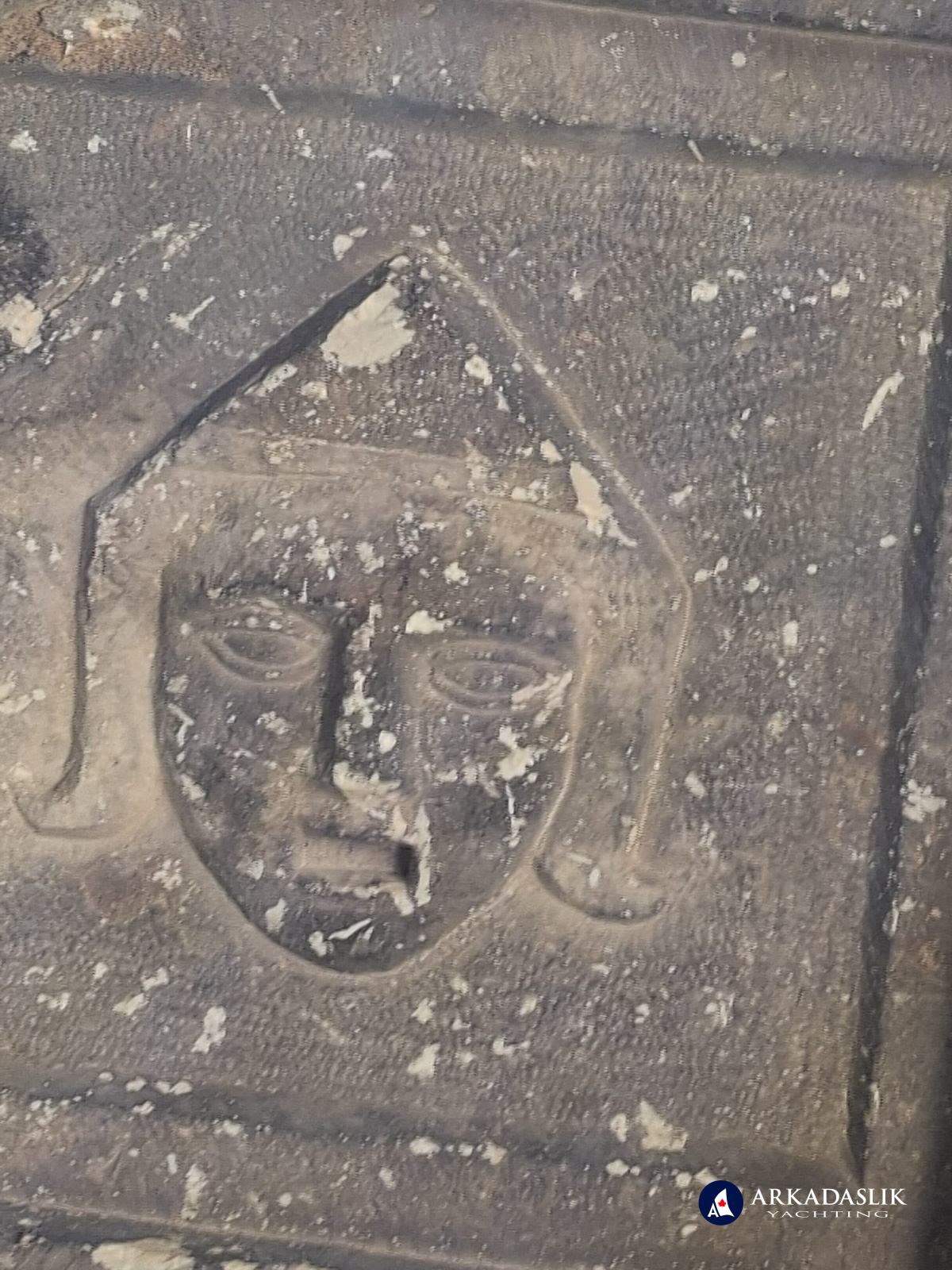 Decorated face carved into the ceiling coffers of the Sidyma tomb