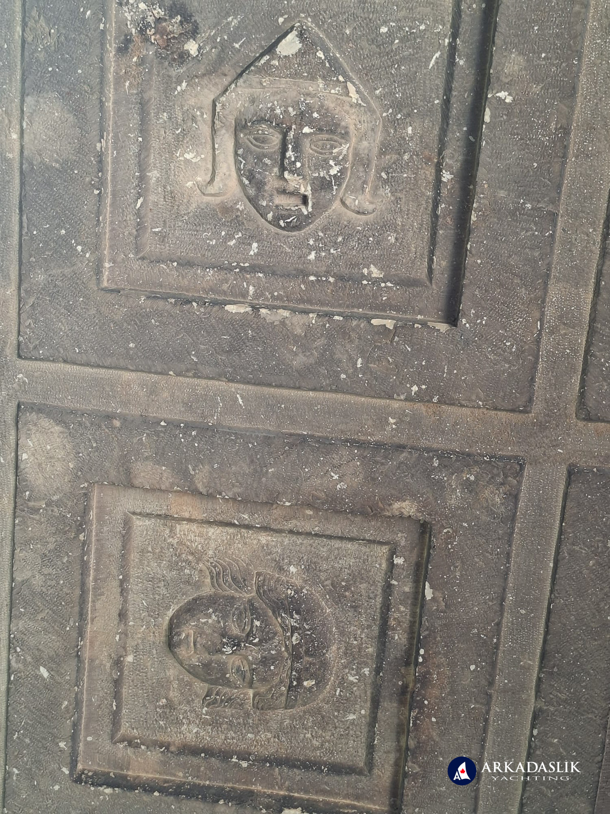 Two carved faces from the cassette-ceiling tomb at Sidyma