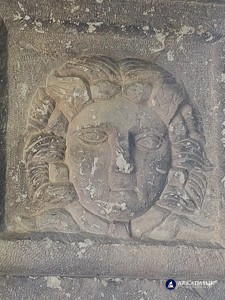 Carved face on a section of the Sidyma cassette-ceiling tomb