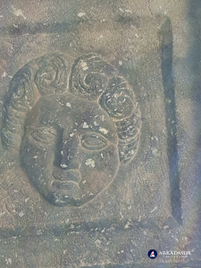 Close-up of one of the carved faces in the Sidyma tomb ceiling