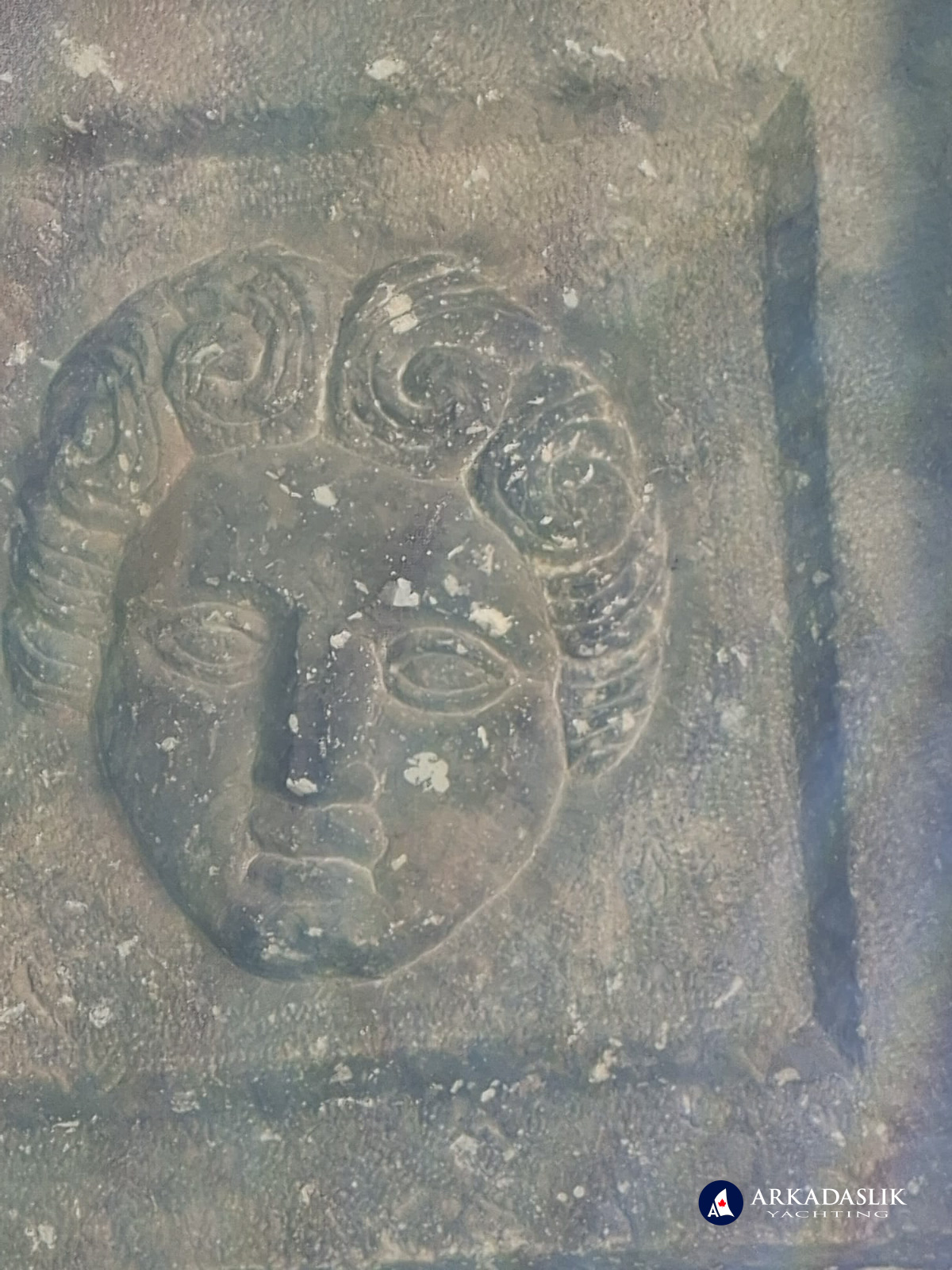Close-up of one of the carved faces in the Sidyma tomb ceiling