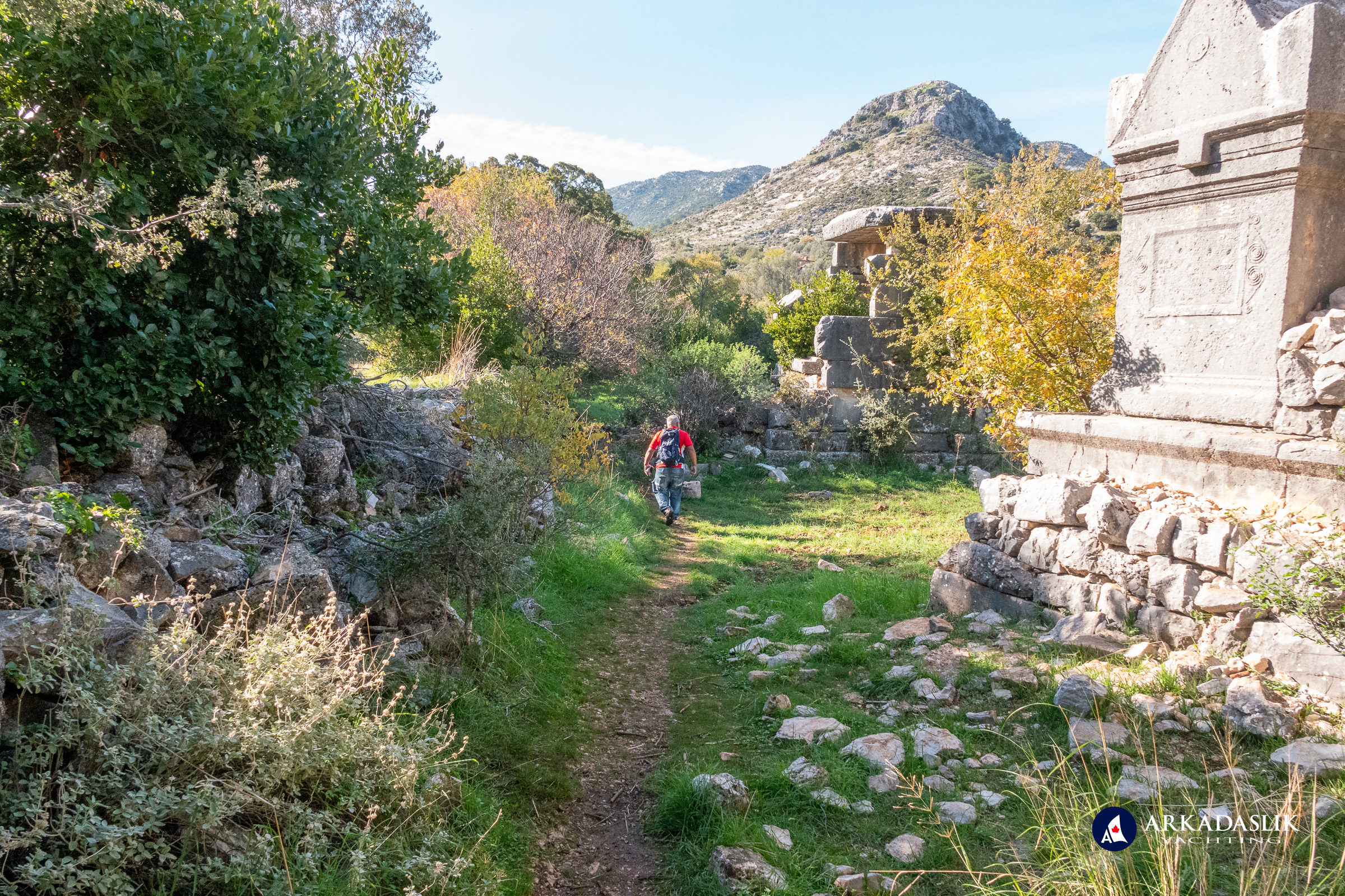 Visitor walking past the cassette-ceiling tomb at Sidyma